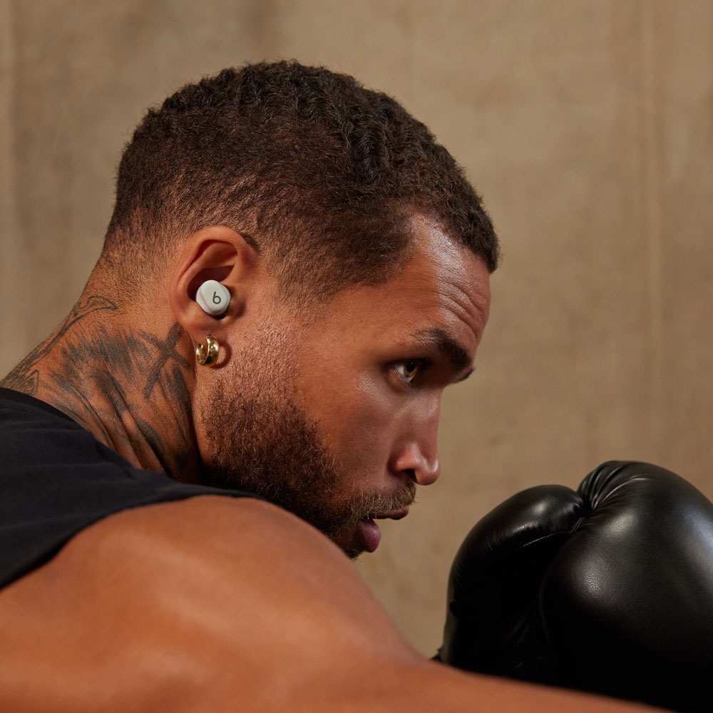 Person wearing Beats Solo Buds in Matte Black while exercising. 